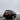 Black Toyota Land Cruiser with illuminated LED tail lights driving along a foggy winter road.