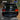 This comparison shows the same Toyota Land Cruiser rear view divided vertically. The left side retains the original OEM tail light, while the right side displays the illuminated PRISMBEAM upgraded tail light.