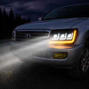 Toyota Land Cruiser LED headlight with turn signal and projector beams at dusk | SKU: H-LC100-04
