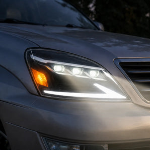 PRISMBEAM triple projector LED headlights installed on a 2003-2009 Lexus GX470 at dusk