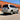 A white Lexus GX 470 is shown from a rear three-quarter angle with a mirrored pair of powered-off LED tail lights. The smoked lenses, dark L-shaped guides, chrome outer trim, and lower horizontal sections are visible.