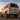 This compatibility image shows a 2003–2009 Lexus GX 470 fitted with PRISMBEAM LED tail lights. The low rear three-quarter view highlights the illuminated red housings, amber L-shaped signatures, segmented columns, and lower dual-color sections.