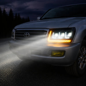 Toyota Land Cruiser LED headlight with turn signal and projector beams at dusk | SKU: H-LC100-04